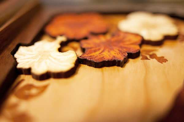 Flower artwork detail in Walnut wood urn