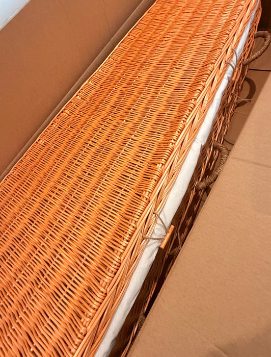 Willow casket inside cardboard box