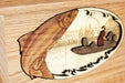 A woodcarved salmon leaps in the foreground